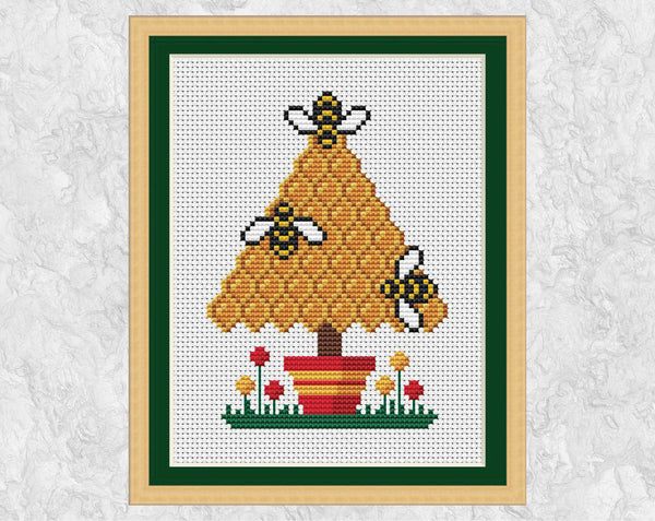 Bee Christmas Tree cross stitch pattern - bees and honeycomb forming a tree shape - shown with frame