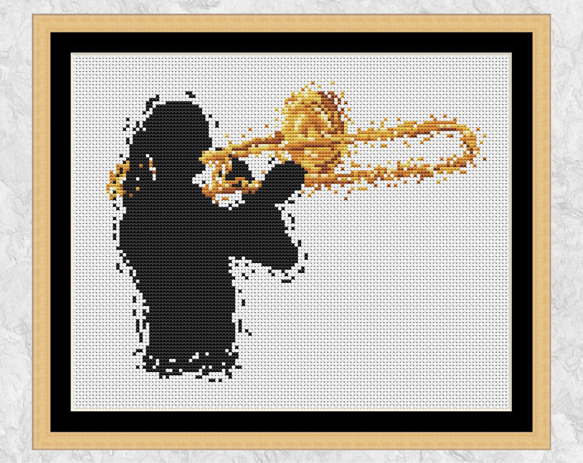 Modern art cross stitch pattern of a female trombonist. Shown with frame.