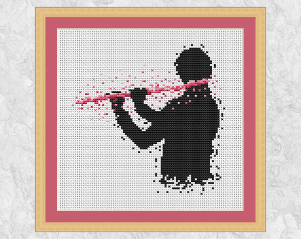 Male flutist or flute player music cross stitch pattern. Pink colourway shown with frame.