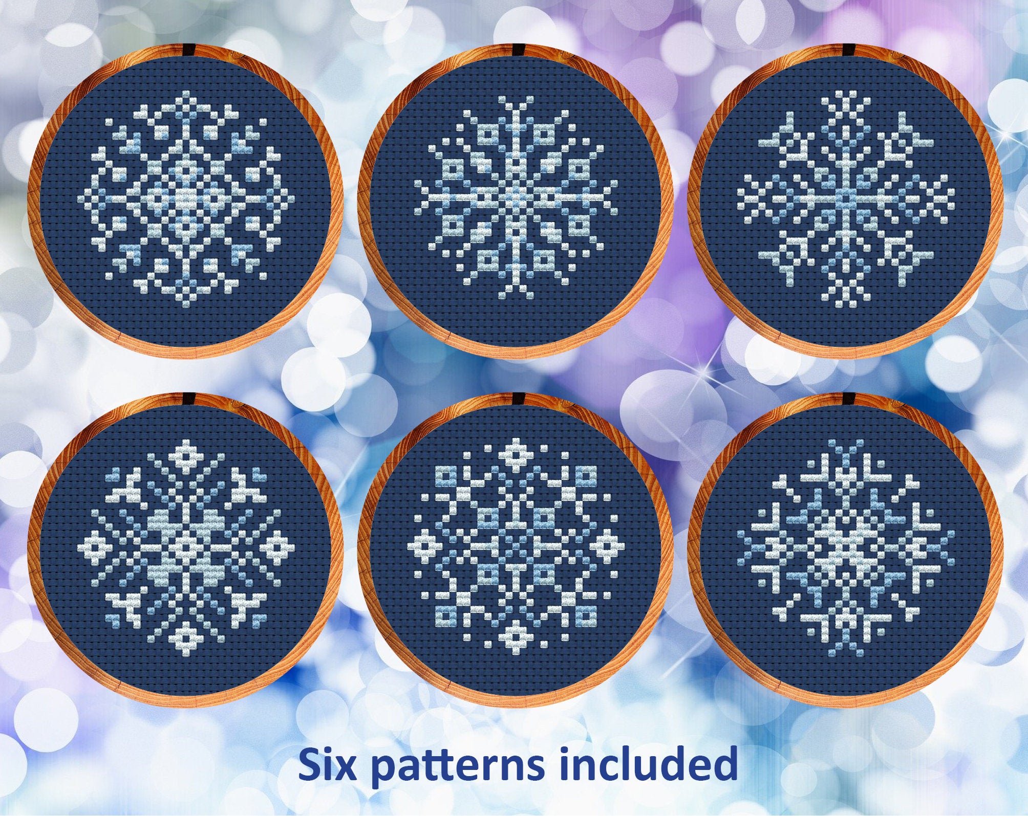 Six mini snowflake cross stitch patterns in shades of pale blue on dark blue fabric