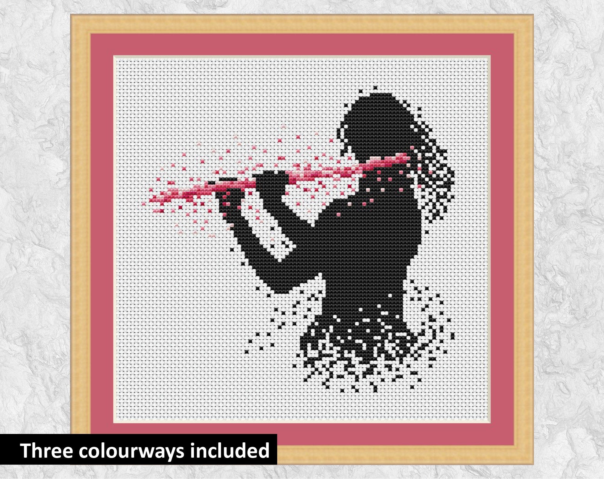 Female flutist or flute player music cross stitch pattern. Pink colourway shown with frame.