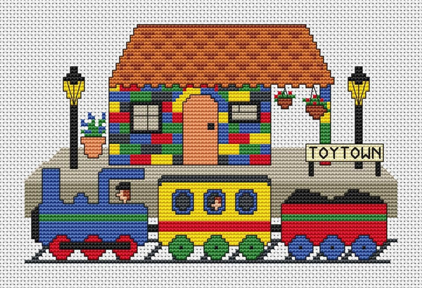 Toy Train and Station cross stitch pattern - cartoon train arriving at Toytown Station, made of colourful toy bricks. Shown without frame.