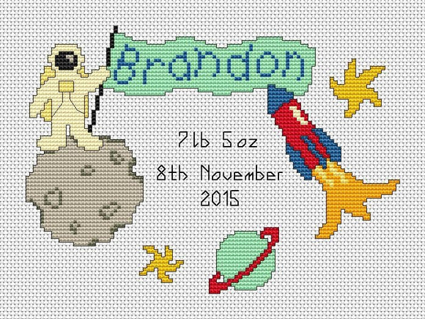Custom cross stitch pattern of an astronaut holding a flag which will feature a name of your choice. An example name and birth details are shown in the image. Shown without frame.